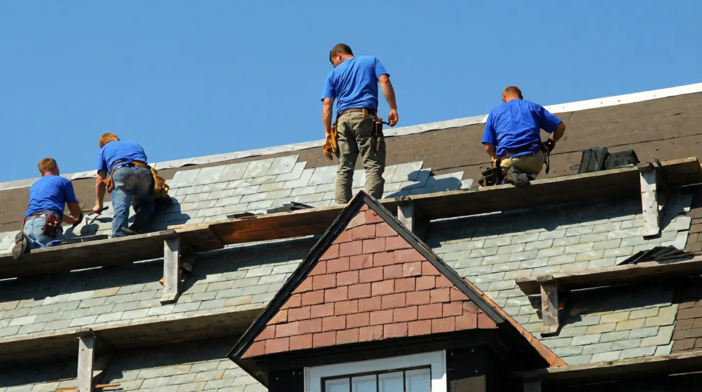 Roof replacement in progress with a team of professional contractors installing new shingles on a residential home in Fort Wayne, IN