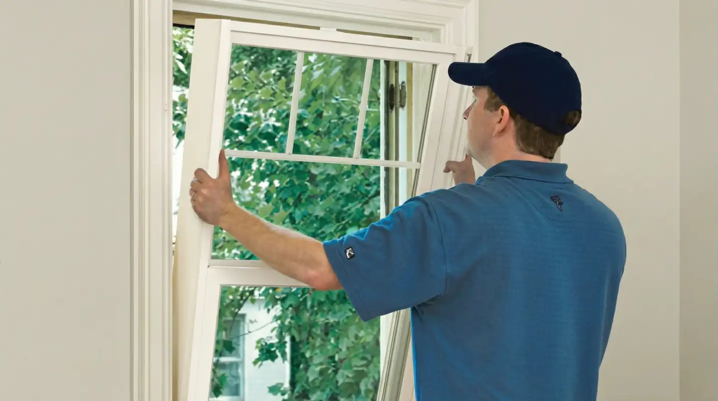 Professional contractors performing a residential window insulation and replacement service in Fort Wayne, IN